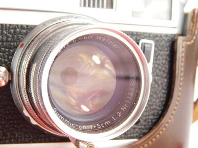 A Leica M4 camera, serial number 1270524, with a Leitz 5cm f2 Summicron lens, number 1156983, in a leather case. - 2