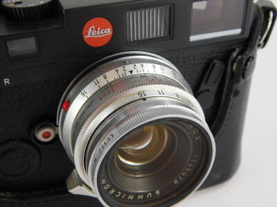 A black Leica M6 camera, with a Leitz 35mm f wide angle Summicron lens, number 1745070, in a leather case. - 3