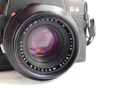 A black Leica R4 single lens reflex camera, with a Leitz Summicron 50mm f2 lens, number 2666242. - 2