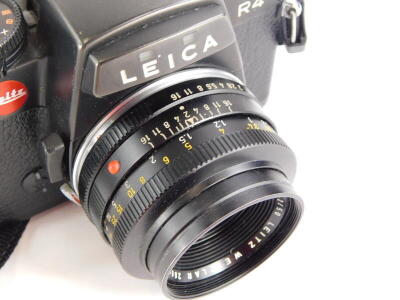 A black Leica R4 single lens reflex camera, with a Leitz Summicron 50mm f2 lens, number 2666242. - 3