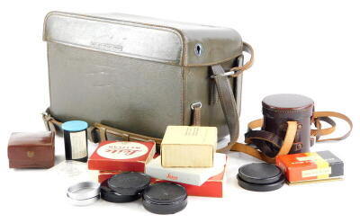 A brown leather Leica holdall case, containing mixed Leica accessories.