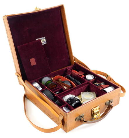 A tan bespoke pigskin suitcase, containing mixed Leica accessories.