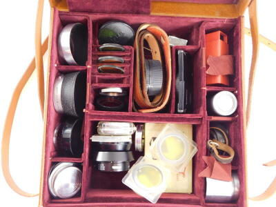 A tan bespoke pigskin suitcase, containing mixed Leica accessories. - 2