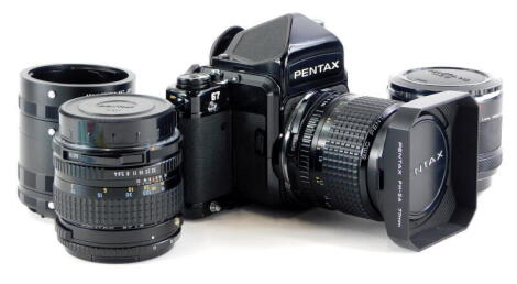 A Pentax 67 camera, with 55mm f4 SMC lens and hood, and a 165mm f4 SMC lens, with a set of auto extension tubes.