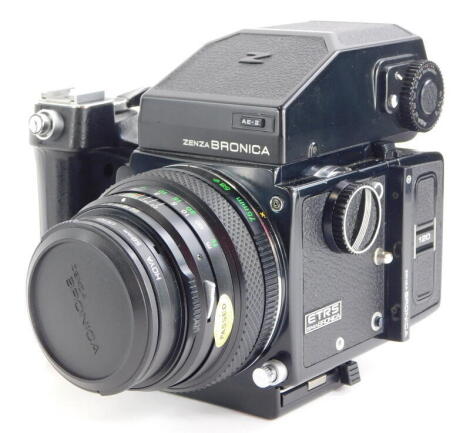 A Zenza Bronica ETRS SLR film camera, fitted with a Zenzanon 75mm f2.8 lens, with a Zenzanon 150mm f4 medium Telephoto lens, 120 and 35mm film back, a lens hood, and four instruction booklets. The camera features an AE-11E through the lens metering prism 