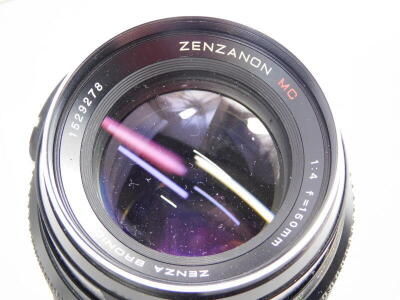 A Zenza Bronica ETRS SLR film camera, fitted with a Zenzanon 75mm f2.8 lens, with a Zenzanon 150mm f4 medium Telephoto lens, 120 and 35mm film back, a lens hood, and four instruction booklets. The camera features an AE-11E through the lens metering prism - 5