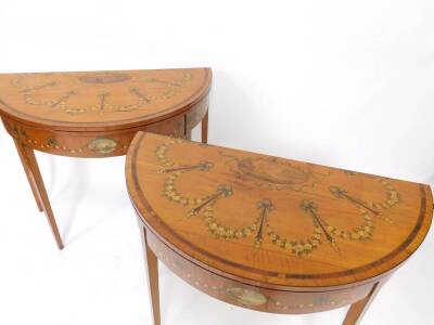 A pair of 19thC Sheraton revival hand painted satinwood demi lune card tables, with baize lined folding tops, oval painted vignettes within painted swags with urns, raised on square taper legs, 77cm high, 46cm deep. - 2