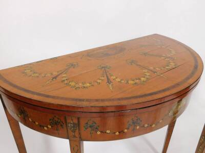 A pair of 19thC Sheraton revival hand painted satinwood demi lune card tables, with baize lined folding tops, oval painted vignettes within painted swags with urns, raised on square taper legs, 77cm high, 46cm deep. - 4