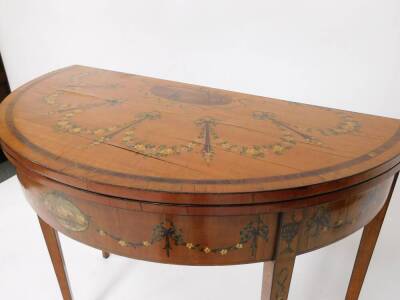 A pair of 19thC Sheraton revival hand painted satinwood demi lune card tables, with baize lined folding tops, oval painted vignettes within painted swags with urns, raised on square taper legs, 77cm high, 46cm deep. - 11