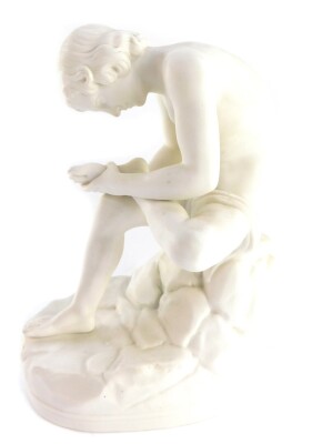 A late 19thC parian porcelain figure of The Spinario, After The Antique, raised on a naturalistic oval base, stamped BC187, 28cm high.