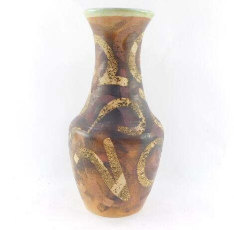 A Raymond Everett of Rye pottery vase, c1960's, decorated with stylised figural motifs against a brown ground, printed mark, 43cm high.