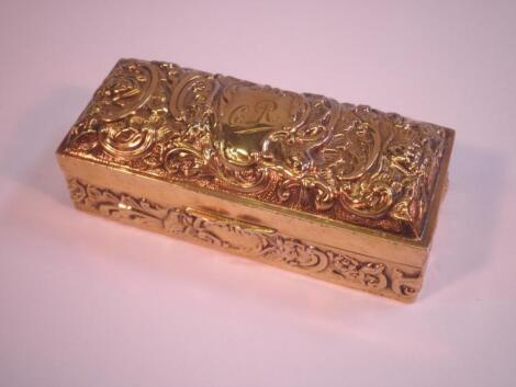 A rectangular gilt box and cover embossed with scrolls and masks