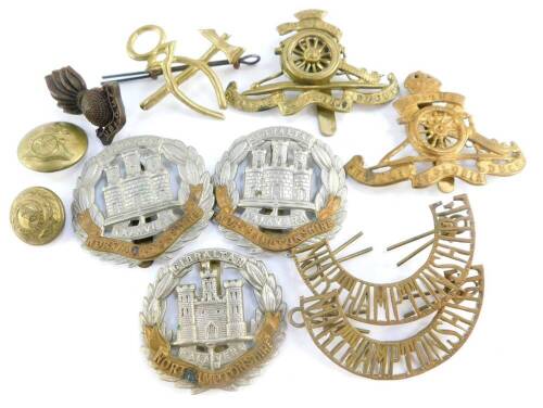 Military cap badges and buttons, including the Northamptonshire Regiment, and Royal Artillery. (a quantity)