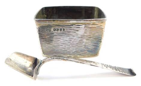 A Victorian silver salt, and spoon, of textured form, Jonathan Wilson Hukin and John Thomas Heath, London 1885, 1.75oz.
