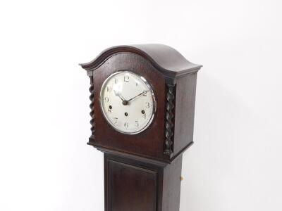 A Kenzle early 20thC oak cased grandmother clock, circular silver dial bearing Arabic numerals, eight day movement with Westminster chimes, the case hood with spiral twist columns, trunk door with panelled motif, raised on bracket feet, with key, 147cm hi - 2