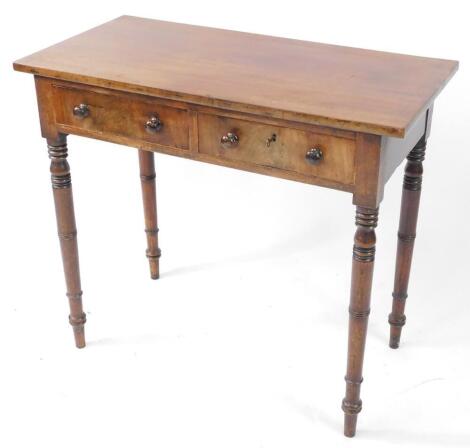 A late Georgian mahogany side table, with two frieze drawers, one lockable, raised on ring turned legs, 74.5cm high, 84.5cm wide, 42.5cm deep.