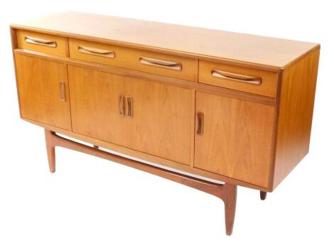 A G plan teak sideboard, with one long flanked by two short drawers, over four cupboard doors, raised on tapering square legs, 84cm high, 152cm wide, 45.5cm deep.