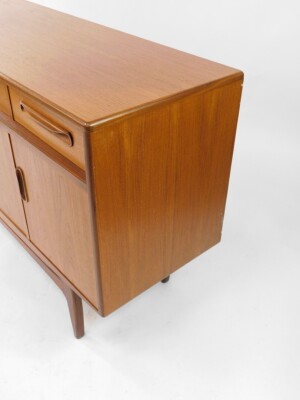 A G plan teak sideboard, with one long flanked by two short drawers, over four cupboard doors, raised on tapering square legs, 84cm high, 152cm wide, 45.5cm deep. - 4