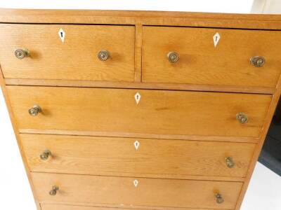 A mid century Georgian style light oak chest, of two short over five long drawers, raised on tapering square legs, 128cm high, 84cm wide, 45cm deep, together with a dressing table, the domed swing framed mirror over one long flanked by four deep drawers, - 6