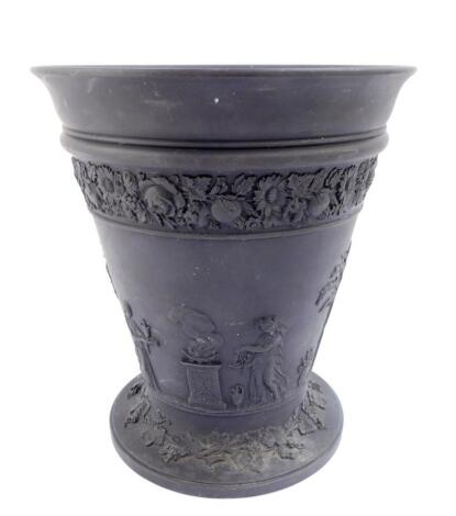 A 20thC Wedgwood black basalt vase, of tapering footed form, liner lacking, traditionally decorated with a band of classical figures, within bands of flowers and vines, impressed marks, 19.5cm high.