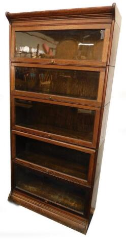 An oak Globe Wernicke style bookcase, of five sections, raised on a plinth base, 181cm high, 86.5cm wide, 33cm deep.