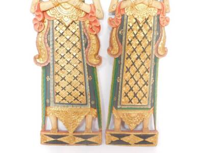 A pair of Balinese wooden carvings of male and female deities, modelled in standing pose, 97cm high. - 2