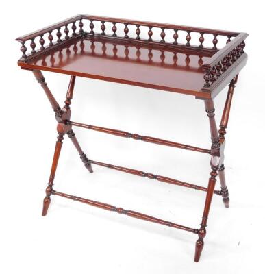 A mahogany butler's tray top table, with a three sided gallery raised on X frame supports, united by turned stretchers, 85cm high, 82cm wide, 47.5cm deep.