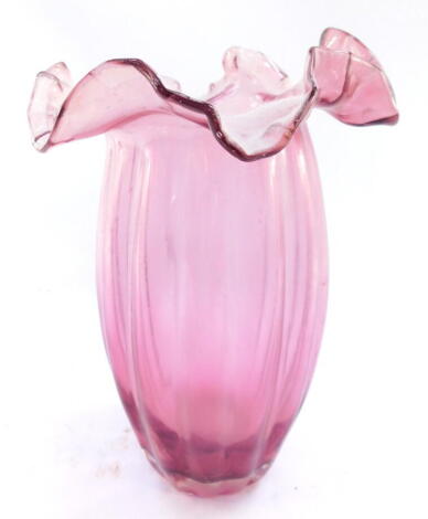 A Victorian cranberry glass ribbed vase, with a wavy frilled neck, 27cm high.