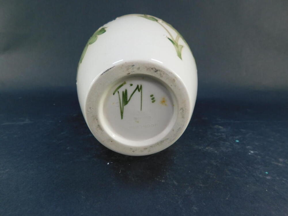 A Moorcroft pottery vase decorated in the Columbine pattern, against a cream ground, of ovoid