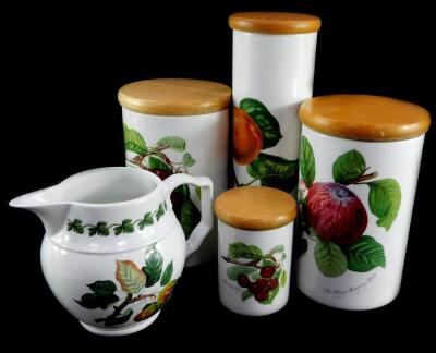 Four Portmeirion pottery storage jars decorated in the Pomona pattern, with wooden lids, together with a Pomona pattern water jug. (5)