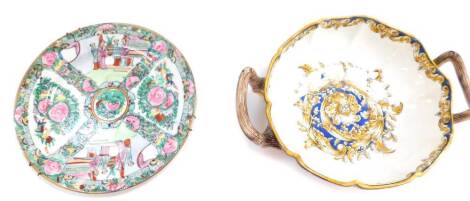 An Italian majolica twin handled bowl, of fluted form, with decoration of floral cornucopia and foliate scrolls, against a blue ground, 35cm diameter, together with a Chinese Republic famille rose plate decorated with reserves of figures, birds and flower