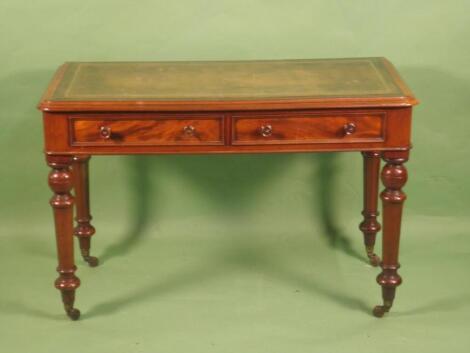 A Victorian mahogany writing table with a green leather inset