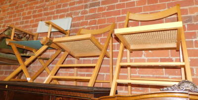 A folding director's chair, together with two folding cane seated chairs. (3)