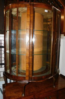 A mid 20thC walnut bowfront china cabinet, enclosing two glass shelves, 116cm high, 97cm, wide, 36cm deep.