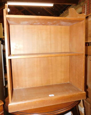 A blonde oak floor standing bookcase, of two shelves, 81cm high, 64cm wide, 23cm deep.