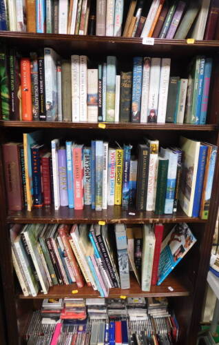 Books to include hardback, etc., Seton (Earnest Thompson) Animal Heros., biographies including Harry Secombe., Patsy Palmer., Julie Andrews., Cooper (Jilly), Wicked., Pam Ayres, etc., videos, music CDs, cassettes, archeology, etc. (5 shelves)