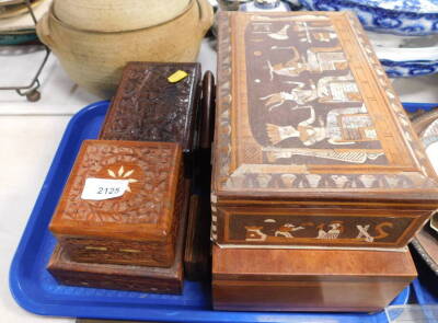 A heavily carved Eastern box, together with other boxes, one of square form, one with mother of pearl inset figures, 25cm wide, etc. (1 tray)