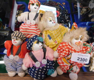 Five vintage models of clowns, with porcelain faces, variously attired, 10cm high.