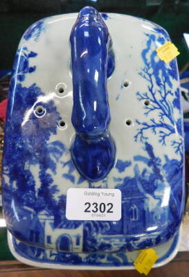 A reproduction blue and white pottery cheese dish and cover.