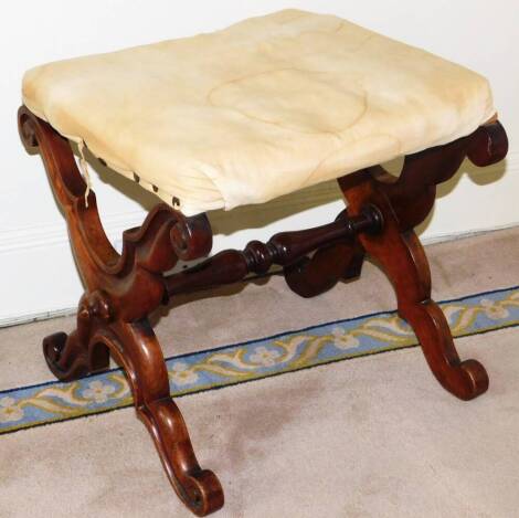 A Victorian walnut X framed stool, with cream upholstered cushioned seat, scroll carved X frame base, 42cm high, 41cm wide, 40cm deep.