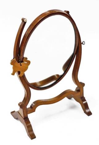 A late 19thC walnut swing frame dressing table mirror, with oval mirror plate, 49cm high, 32cm wide.