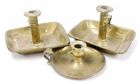 Three Victorian brass chambersticks, a near pair 13cm high, and a single squat example, 7cm high. (3)