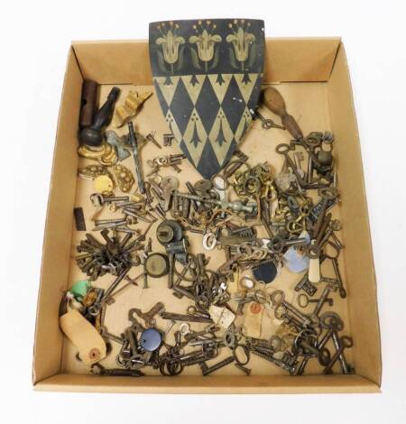 Old keys, hooks and ironmongery, including a painted armorial shield.