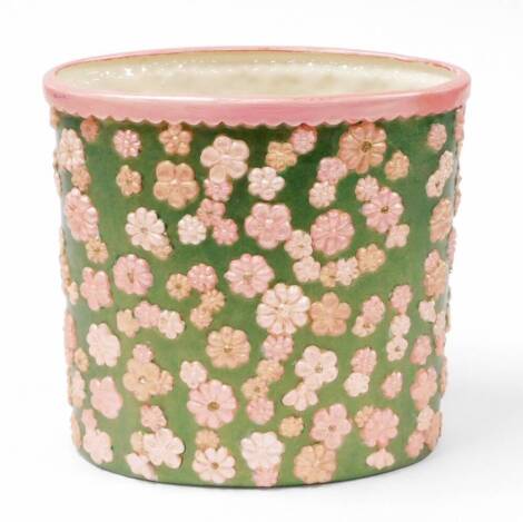 A 1960's/70's ceramic planter, later painted on green ground with pink flowers and pink border, unmarked, 25cm high, 26cm diameter.