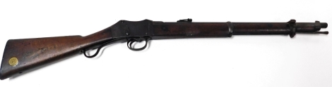 A Victorian Martini Enfield carbine, stamped VR over ENFIELD, dated 1873, the mahogany butt having brass disc stamped R.I.C. 1497, obsolete calibre .577/450, 96cm long.