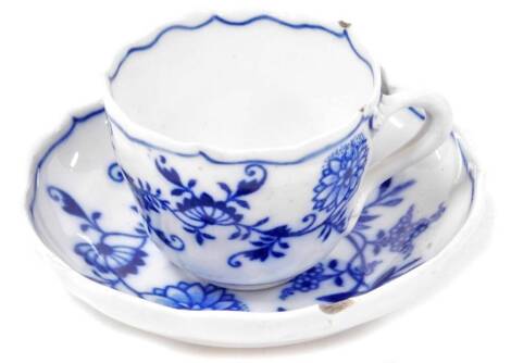 A Meissen blue and white cup and saucer, the tea cup with flowers and leaves with acanthus leaf handle, on shaped saucer dish, with Meissen shield stamp on saucer, 10cm diameter, 5cm high.