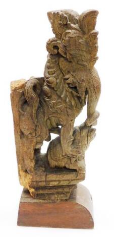 A carved Indian hardwood group, in the form of two elephants, each in heavy Eastern dress, 46cm high, 17cm wide.