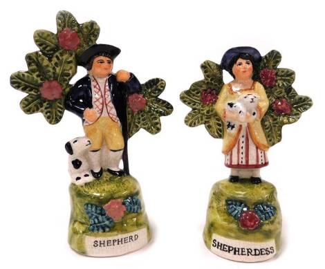 Two Staffordshire style figures, of the shepherd and shepherdess, each with animal, the shepherd 17cm high, the shepherdess 15cm high, unmarked.