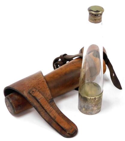 An early 20thC hunting flask, with glass body and silver plated cap ends, in a leather carrying satchel, 25cm high.