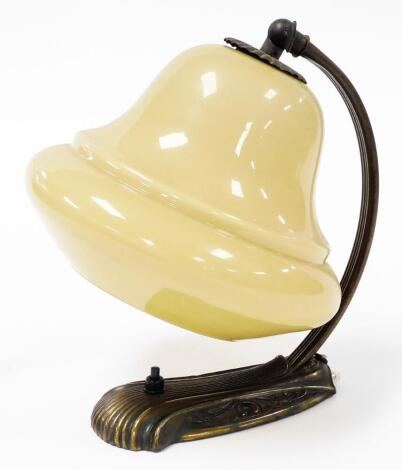 A 1960s/70s desk lamp, the arched brass finish frame, with a yellow domed glass shade, 25cm high.